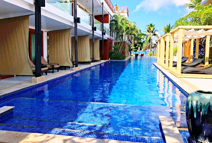 白い壁のモダンな建物と、中庭のプール